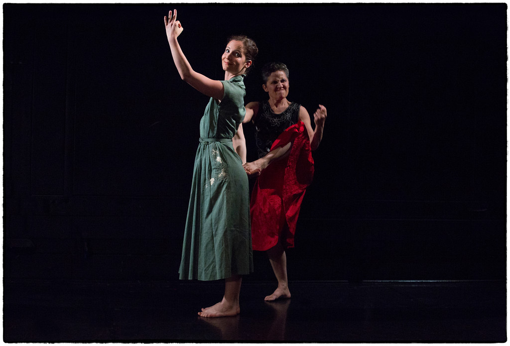 Cecily Stewart makes a gesture above her ahead smiling at the audience while Misa Kelly gives a disgruntled look